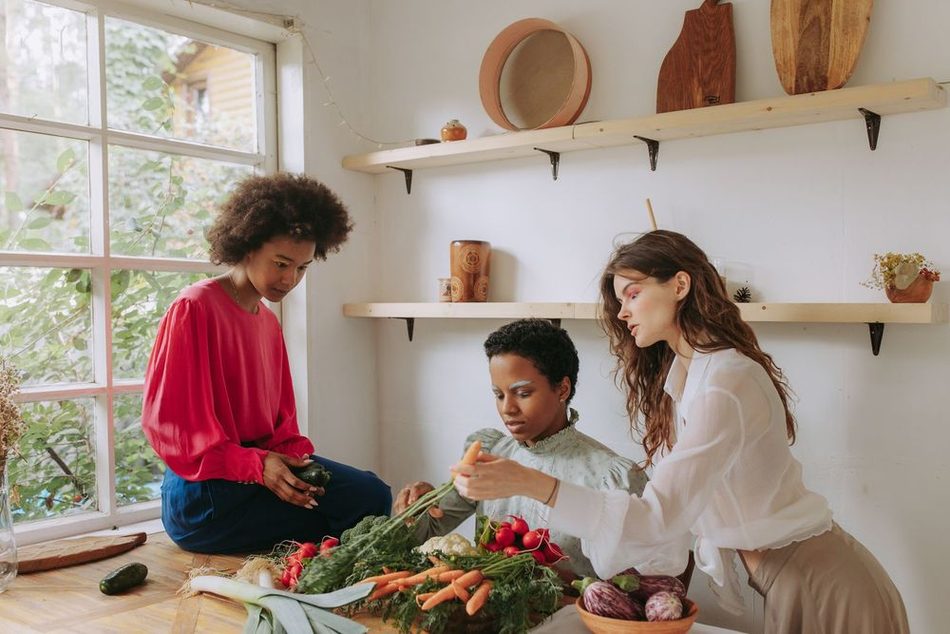 A volunteer handing fresh produce to a community member