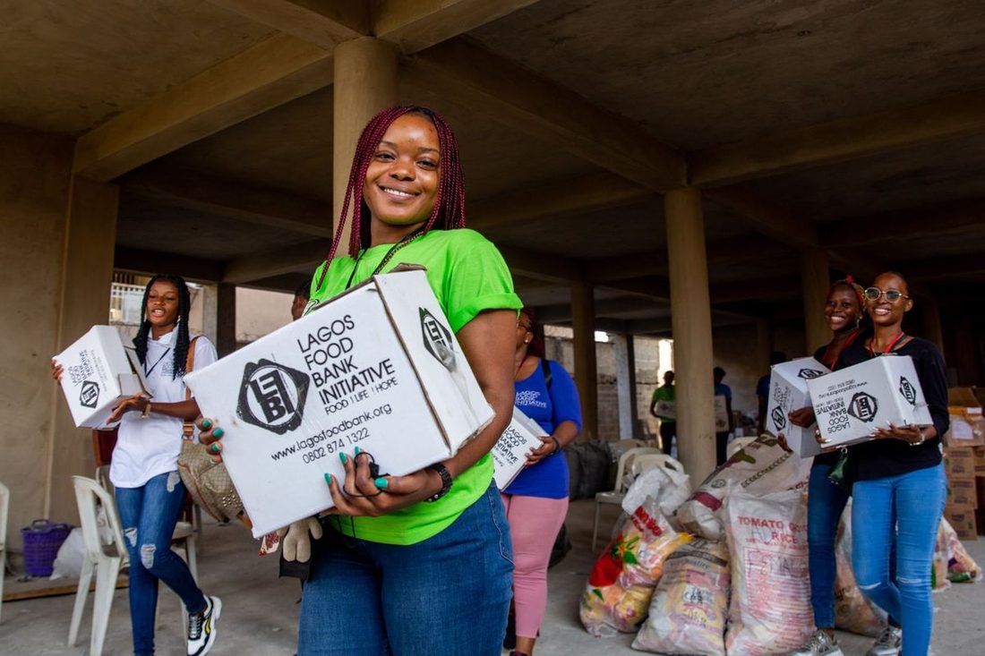 Volunteers sorting and packing food at a community food program
